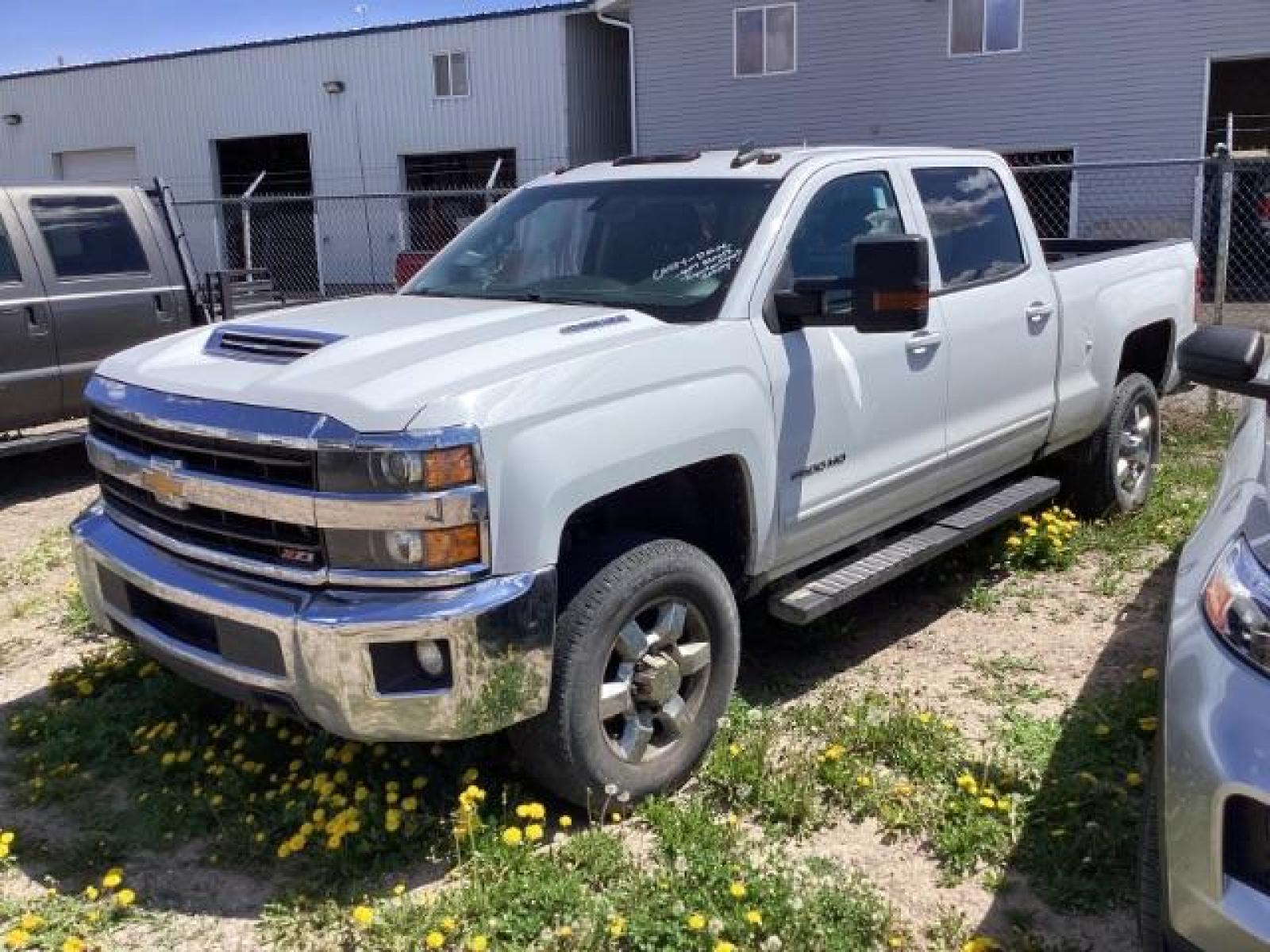 2018 Summit White Chevrolet Silverado 2500HD LT Crew Cab Long Box 4WD (1GC1KVEY6JF) with an 6.6L V8 OHV 32V TURBO DIESEL engine, 6-Speed Automatic transmission, located at 1235 N Woodruff Ave., Idaho Falls, 83401, (208) 523-1053, 43.507172, -112.000488 - Photo #0