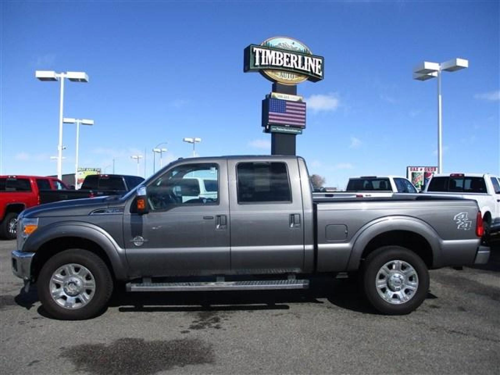 2012 GRAY /BLACK FORD F350 LARIAT (1FT8W3BT1CE) with an 8 engine, Automatic transmission, located at 1580 E Lincoln Rd, Idaho Falls, ID, 83401, (208) 523-4000, 0.000000, 0.000000 - SUPER CLEAN BODY AND PAINT. INTERIOR HAS NO TEARS OR ANYTHING MISSING. MECHANICALLY STOCK. STOCK SUSPENSION. FACTORY RUNNING BOARDS. FIFTH WHEEL RAILS AND REESE HITCH INSTALLED/INCLUDED. TIRES AT 80% TREAD. DUAL POWER SEATS. HEATED AND COOLED SEATS. SUNROOF. TRAILER BRAKE. EXHAUST BRAKE. LOCKING REA - Photo #2