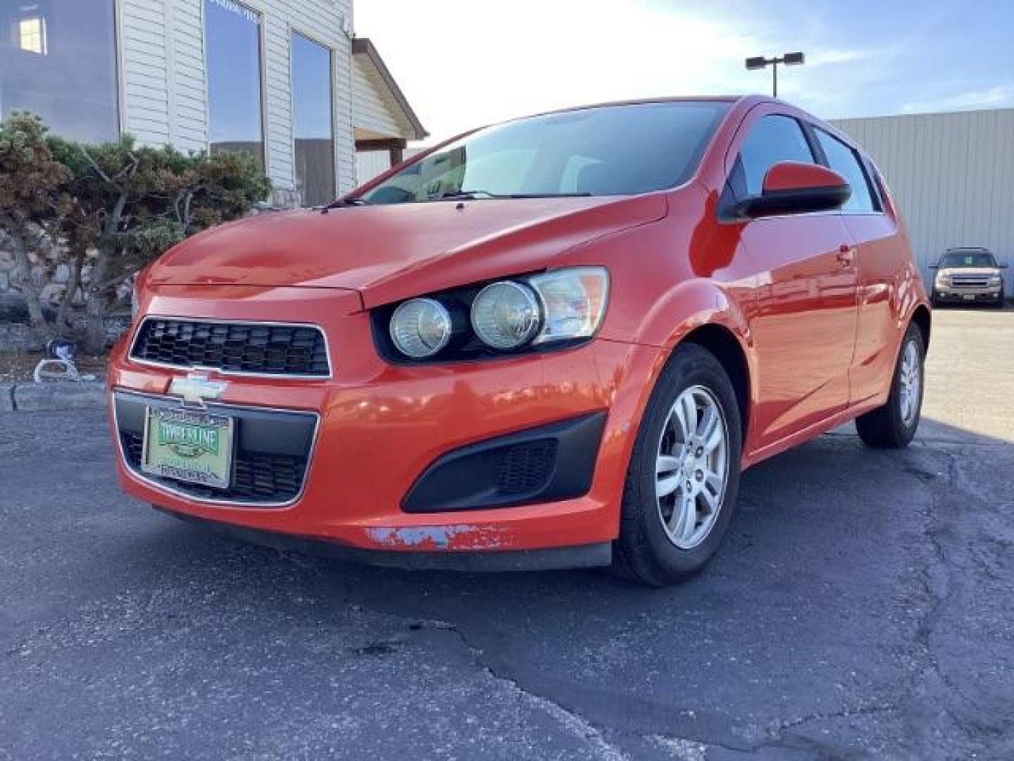 2012 Inferno Orange Metallic /Jet Blk/ Dark Titanium Cloth Interior Chevrolet Sonic 1LT 5-Door (1G1JD6SB5C4) with an 1.4L L4 DOHC 24V TURBO engine, 5-Speed Manual transmission, located at 1235 N Woodruff Ave., Idaho Falls, 83401, (208) 523-1053, 43.507172, -112.000488 - Get ready to enjoy a spirited drive with this 2012 Chevrolet Sonic Hatchback 1LT! Equipped with a peppy 1.4L turbocharged engine, this compact hatchback delivers impressive fuel efficiency without sacrificing performance. Perfect for urban commuting or weekend getaways, the Sonic combines style and - Photo#1