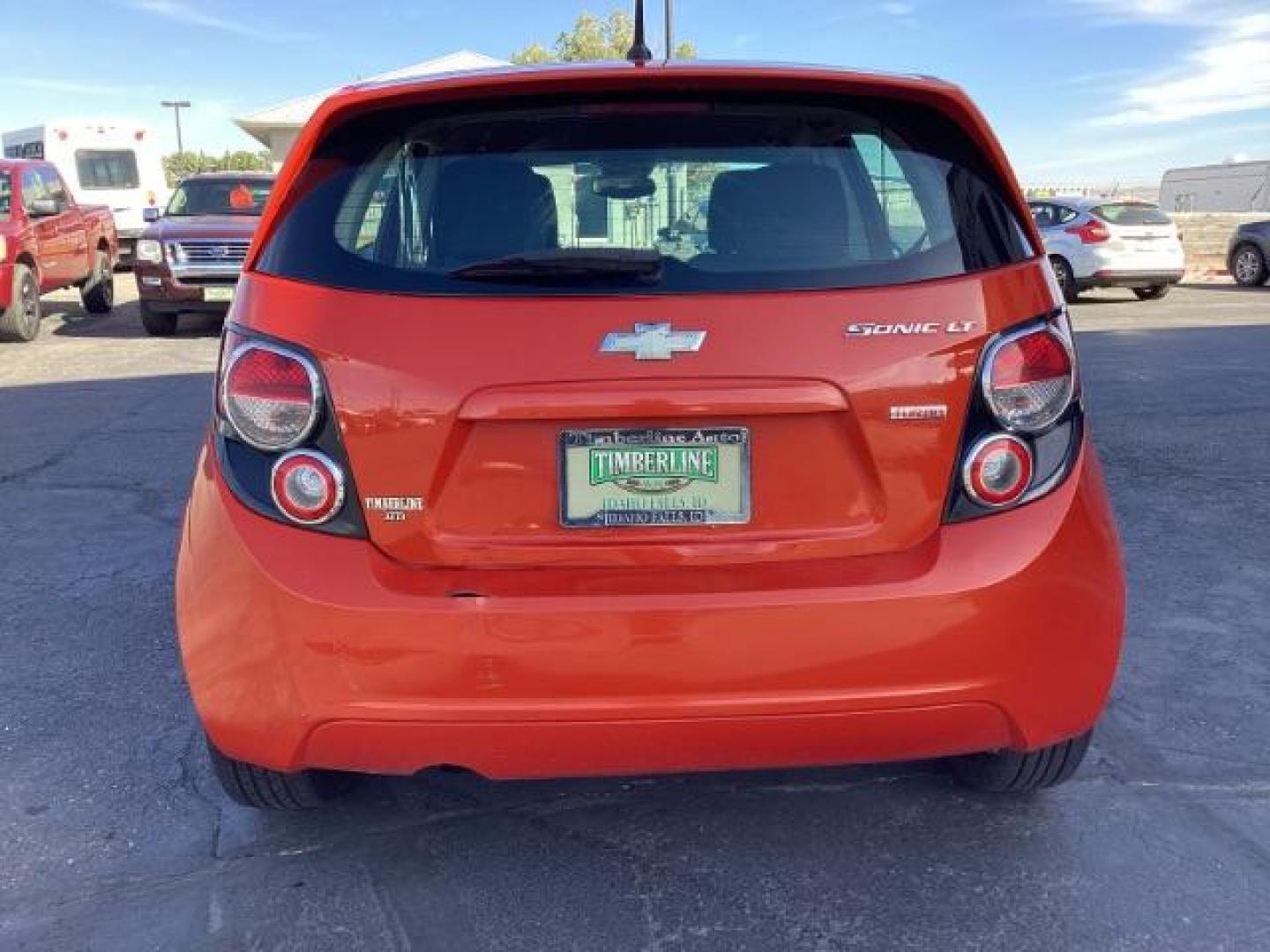 2012 Inferno Orange Metallic /Jet Blk/ Dark Titanium Cloth Interior Chevrolet Sonic 1LT 5-Door (1G1JD6SB5C4) with an 1.4L L4 DOHC 24V TURBO engine, 5-Speed Manual transmission, located at 1235 N Woodruff Ave., Idaho Falls, 83401, (208) 523-1053, 43.507172, -112.000488 - Get ready to enjoy a spirited drive with this 2012 Chevrolet Sonic Hatchback 1LT! Equipped with a peppy 1.4L turbocharged engine, this compact hatchback delivers impressive fuel efficiency without sacrificing performance. Perfect for urban commuting or weekend getaways, the Sonic combines style and - Photo#4