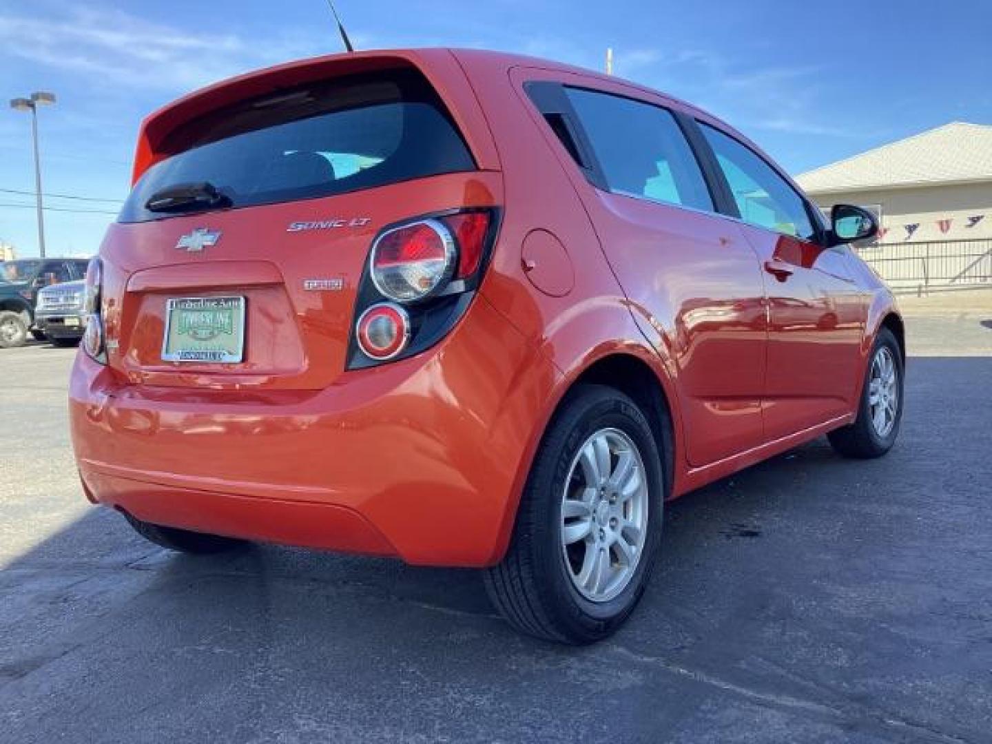 2012 Inferno Orange Metallic /Jet Blk/ Dark Titanium Cloth Interior Chevrolet Sonic 1LT 5-Door (1G1JD6SB5C4) with an 1.4L L4 DOHC 24V TURBO engine, 5-Speed Manual transmission, located at 1235 N Woodruff Ave., Idaho Falls, 83401, (208) 523-1053, 43.507172, -112.000488 - Get ready to enjoy a spirited drive with this 2012 Chevrolet Sonic Hatchback 1LT! Equipped with a peppy 1.4L turbocharged engine, this compact hatchback delivers impressive fuel efficiency without sacrificing performance. Perfect for urban commuting or weekend getaways, the Sonic combines style and - Photo#5