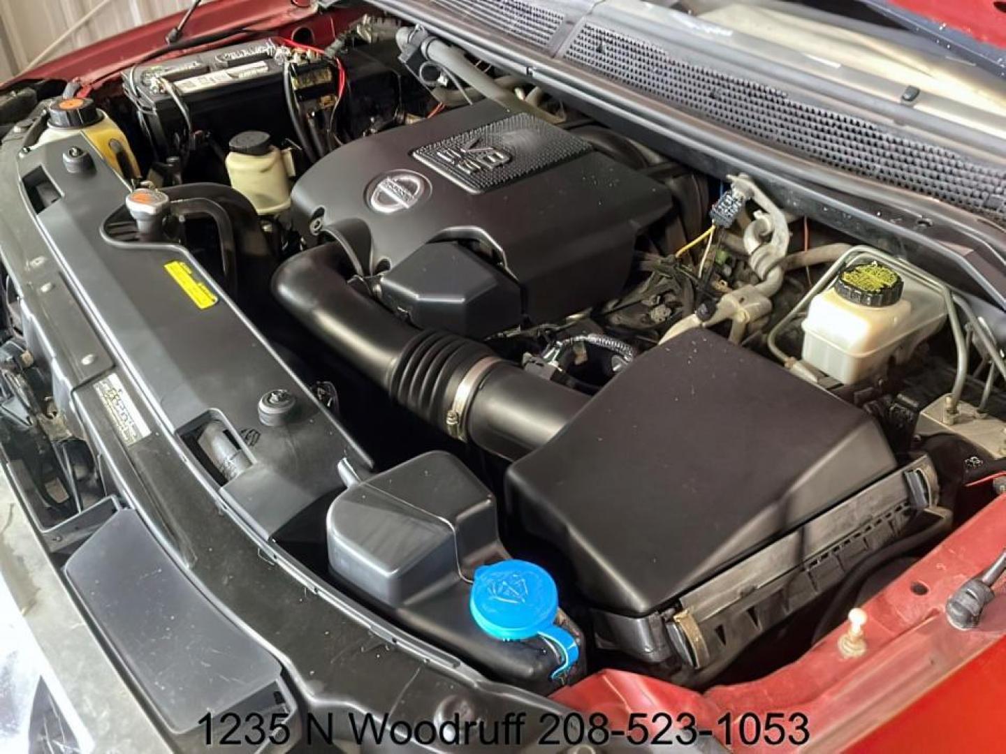 2014 Cayenne Red Metallic /Charcoal Nissan Titan SL Crew Cab 4WD (1N6AA0EC1EN) with an 5.6L V8 DOHC 32V engine, 5-Speed Automatic transmission, located at 1235 N Woodruff Ave., Idaho Falls, 83401, (208) 523-1053, 43.507172, -112.000488 - At Timberline Auto, finding a great deal on your next vehicle is always easy! Our experienced sales staff's goal is to help find you the right vehicle at the right price! Our knowledgeable finance department has options for almost any credit score. We offer extended service contract options to prote - Photo#8