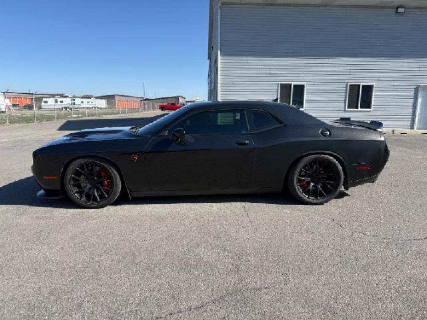2015 Pitch Black Clearcoat /Black/Ruby Red Dodge Challenger Supercharged (2C3CDZC9XFH) with an 6.2L V8 OHV 16V SUPERCHARGED engine, 6-Speed Manual transmission, located at 1235 N Woodruff Ave., Idaho Falls, 83401, (208) 523-1053, 43.507172, -112.000488 - At Timberline Auto, finding a great deal on your next vehicle is always easy! Our experienced sales staff's goal is to help find you the right vehicle at the right price! Our knowledgeable finance department has options for almost any credit score. We offer extended service contract options to prote - Photo#1