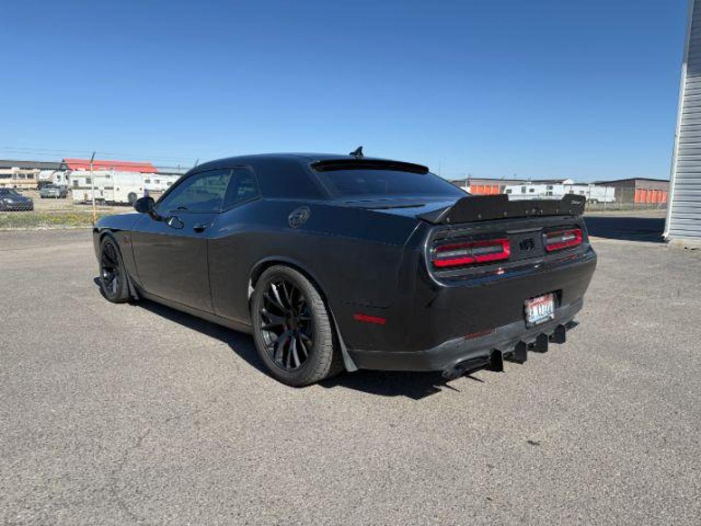 2015 Pitch Black Clearcoat /Black/Ruby Red Dodge Challenger Supercharged (2C3CDZC9XFH) with an 6.2L V8 OHV 16V SUPERCHARGED engine, 6-Speed Manual transmission, located at 1235 N Woodruff Ave., Idaho Falls, 83401, (208) 523-1053, 43.507172, -112.000488 - At Timberline Auto, finding a great deal on your next vehicle is always easy! Our experienced sales staff's goal is to help find you the right vehicle at the right price! Our knowledgeable finance department has options for almost any credit score. We offer extended service contract options to prote - Photo#2