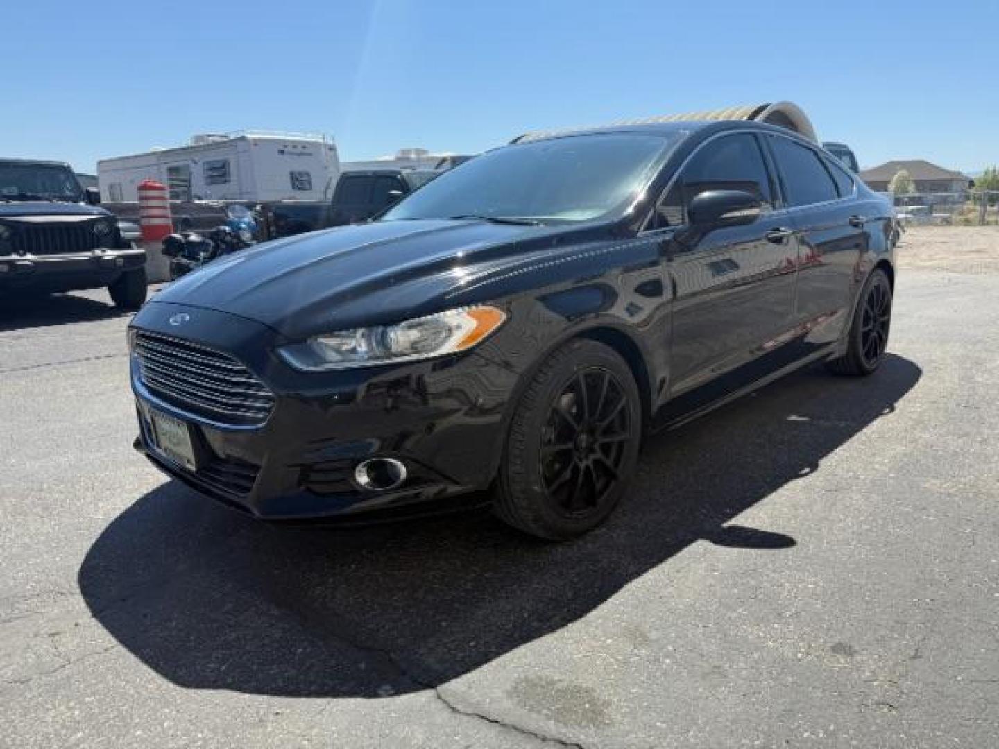 2016 Shadow Black /Charcoal Black Ford Fusion Titanium (3FA6P0K9XGR) with an EcoBoost 2L I-4 gasoline direct injection engine, AUTOMATIC transmission, located at 1235 N Woodruff Ave., Idaho Falls, 83401, (208) 523-1053, 43.507172, -112.000488 - Photo#0