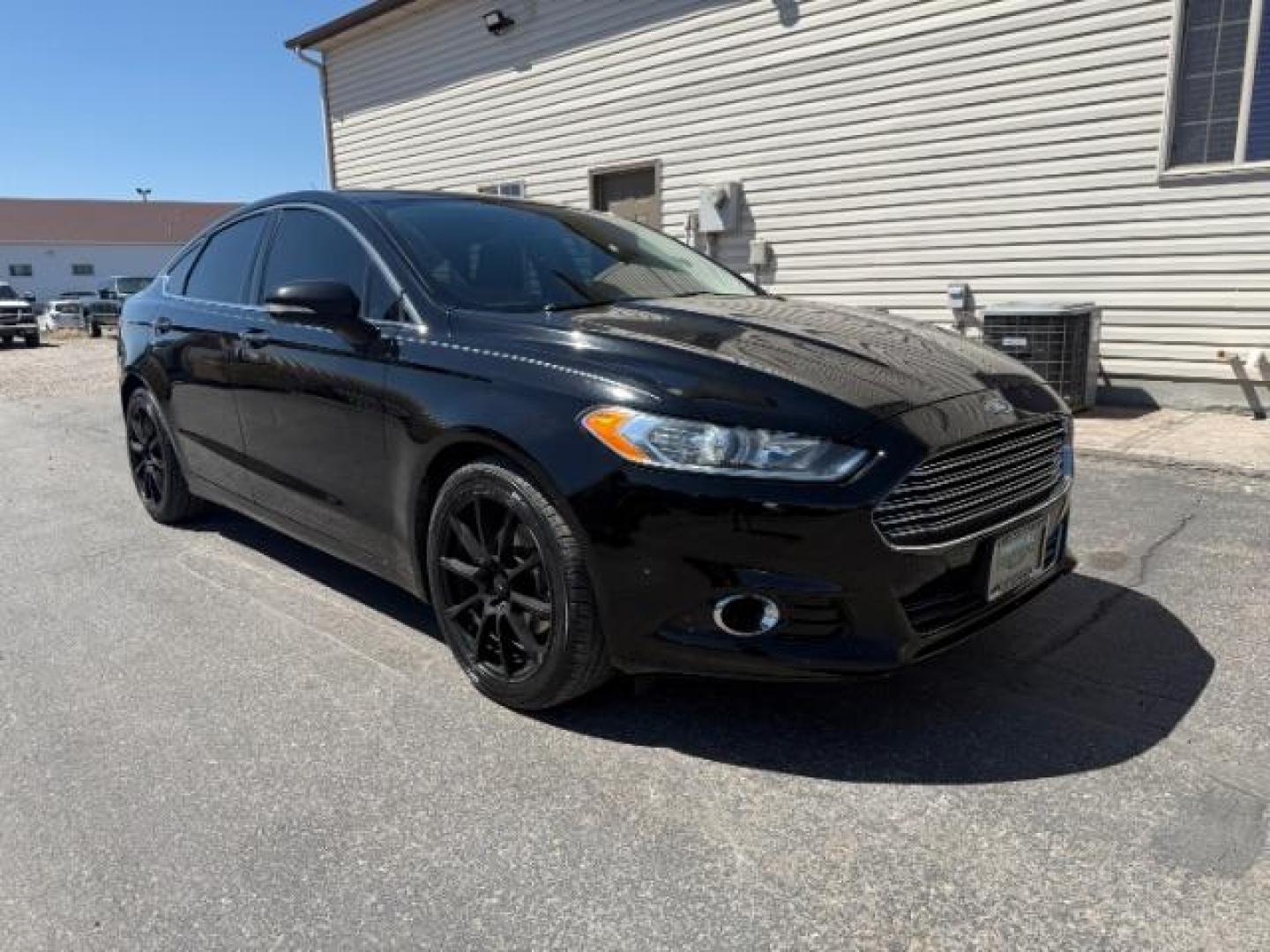 2016 Shadow Black /Charcoal Black Ford Fusion Titanium (3FA6P0K9XGR) with an EcoBoost 2L I-4 gasoline direct injection engine, AUTOMATIC transmission, located at 1235 N Woodruff Ave., Idaho Falls, 83401, (208) 523-1053, 43.507172, -112.000488 - Photo#2