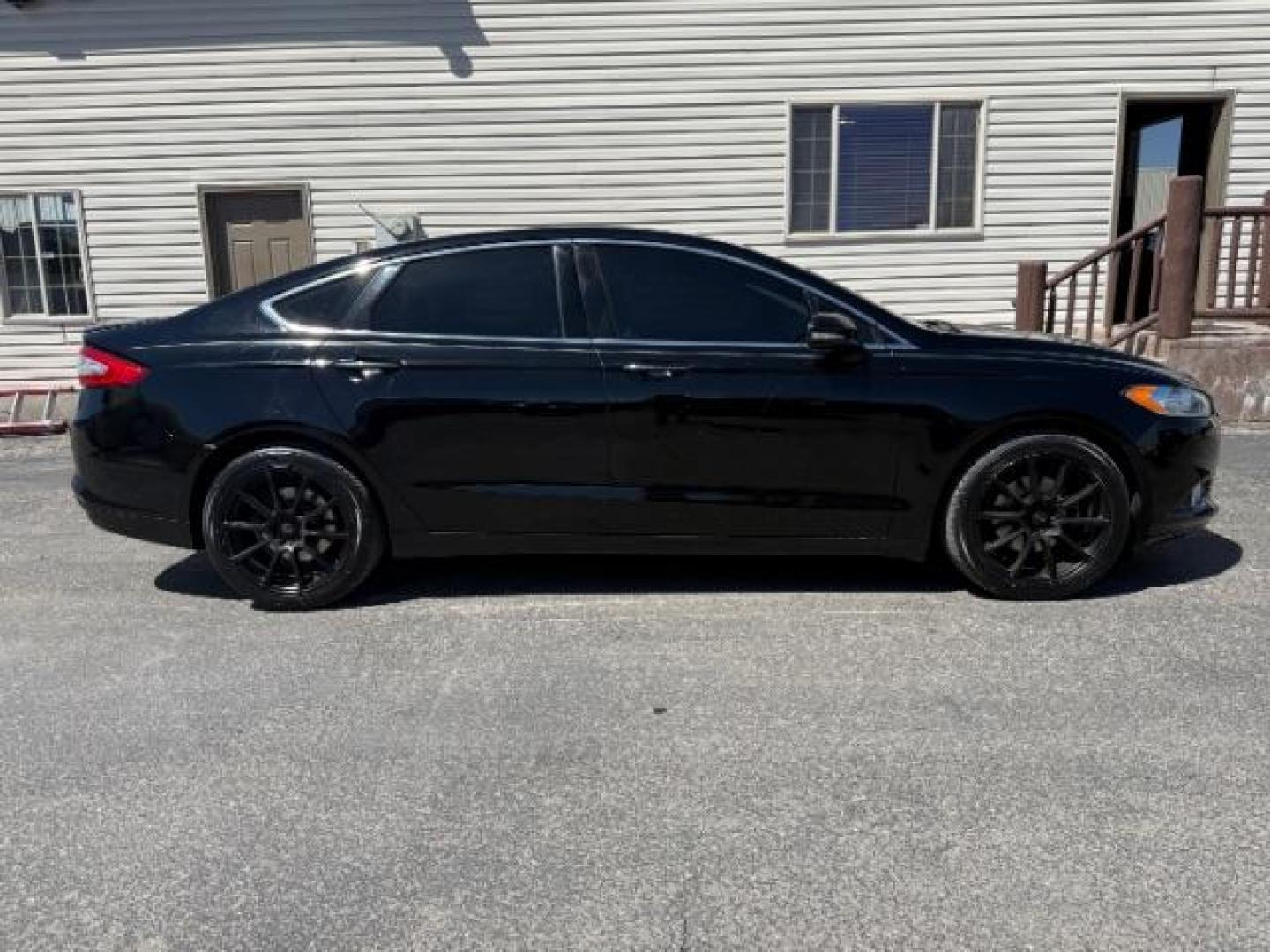 2016 Shadow Black /Charcoal Black Ford Fusion Titanium (3FA6P0K9XGR) with an EcoBoost 2L I-4 gasoline direct injection engine, AUTOMATIC transmission, located at 1235 N Woodruff Ave., Idaho Falls, 83401, (208) 523-1053, 43.507172, -112.000488 - Photo#3