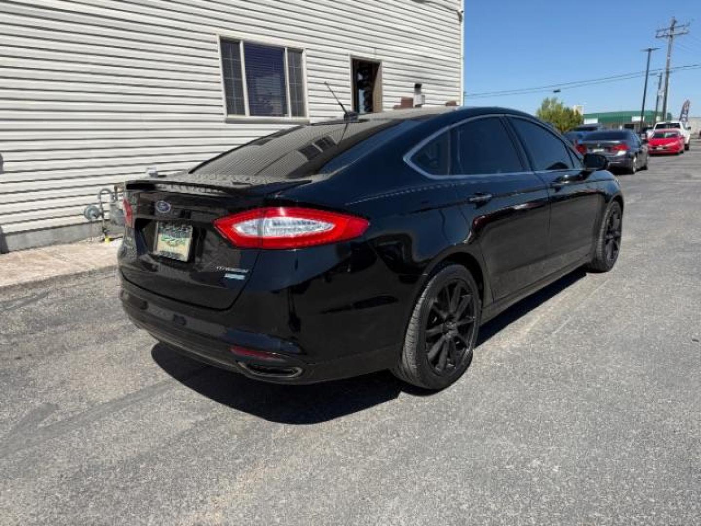 2016 Shadow Black /Charcoal Black Ford Fusion Titanium (3FA6P0K9XGR) with an EcoBoost 2L I-4 gasoline direct injection engine, AUTOMATIC transmission, located at 1235 N Woodruff Ave., Idaho Falls, 83401, (208) 523-1053, 43.507172, -112.000488 - Photo#4