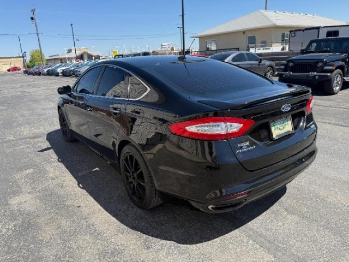 2016 Shadow Black /Charcoal Black Ford Fusion Titanium (3FA6P0K9XGR) with an EcoBoost 2L I-4 gasoline direct injection engine, AUTOMATIC transmission, located at 1235 N Woodruff Ave., Idaho Falls, 83401, (208) 523-1053, 43.507172, -112.000488 - Photo#6