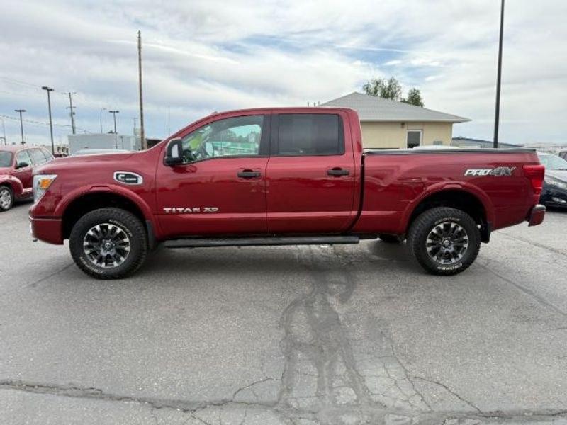 2016 Cayenne Red /Black Nissan Titan XD S (1N6BA1F47GN) with an V8, 5.0L engine, 6-speed automatic transmission, located at 1175 N Woodruff Ave, Idaho Falls, ID, 83401, 43.506901, -111.999657 - <b>Vehicle Details</b><br>Built for hard work and ready for everyday driving, this pre-owned 2016 Nissan Titan XD is a strong choice for drivers seeking capability, comfort, and confidence on the road. Equipped with 4WD and a V8, 5.0L Diesel engine, this Nissan Titan XD delivers impressive towing st- Photo#1