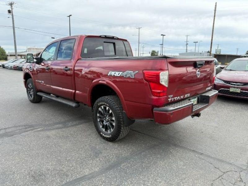 2016 Cayenne Red /Black Nissan Titan XD S (1N6BA1F47GN) with an V8, 5.0L engine, 6-speed automatic transmission, located at 1175 N Woodruff Ave, Idaho Falls, ID, 83401, 43.506901, -111.999657 - <b>Vehicle Details</b><br>Built for hard work and ready for everyday driving, this pre-owned 2016 Nissan Titan XD is a strong choice for drivers seeking capability, comfort, and confidence on the road. Equipped with 4WD and a V8, 5.0L Diesel engine, this Nissan Titan XD delivers impressive towing st- Photo#2