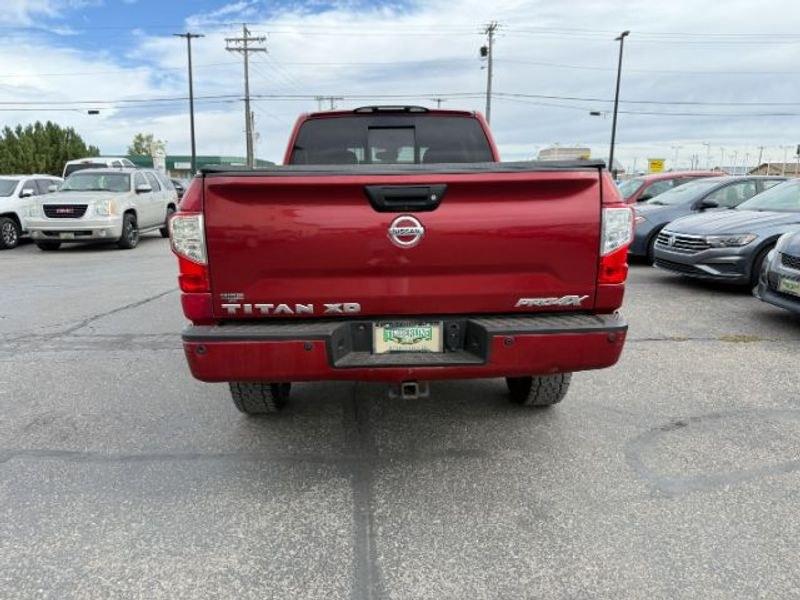 2016 Cayenne Red /Black Nissan Titan XD S (1N6BA1F47GN) with an V8, 5.0L engine, 6-speed automatic transmission, located at 1175 N Woodruff Ave, Idaho Falls, ID, 83401, 43.506901, -111.999657 - <b>Vehicle Details</b><br>Built for hard work and ready for everyday driving, this pre-owned 2016 Nissan Titan XD is a strong choice for drivers seeking capability, comfort, and confidence on the road. Equipped with 4WD and a V8, 5.0L Diesel engine, this Nissan Titan XD delivers impressive towing st- Photo#3
