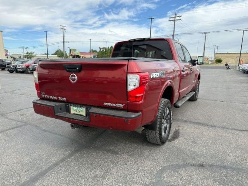 2016 Cayenne Red /Black Nissan Titan XD S (1N6BA1F47GN) with an V8, 5.0L engine, 6-speed automatic transmission, located at 1175 N Woodruff Ave, Idaho Falls, ID, 83401, 43.506901, -111.999657 - <b>Vehicle Details</b><br>Built for hard work and ready for everyday driving, this pre-owned 2016 Nissan Titan XD is a strong choice for drivers seeking capability, comfort, and confidence on the road. Equipped with 4WD and a V8, 5.0L Diesel engine, this Nissan Titan XD delivers impressive towing st- Photo#5