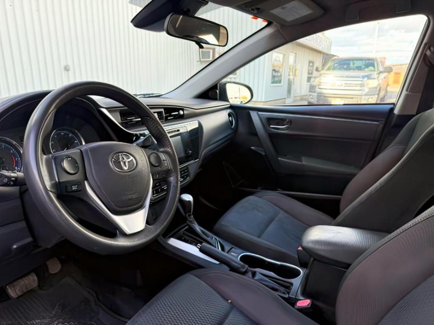 2018 BLACK /Steel Gray Toyota Corolla (5YFBURHE8JP) with an 18L I-4 DOHC engine, Automatic transmission, located at 1175 N Woodruff Ave, Idaho Falls, ID, 83401, 43.506901, -111.999657 - At Timberline Auto, finding a great deal on your next vehicle is always easy! Our experienced sales staff's goal is to help find you the right vehicle at the right price! Our knowledgeable finance department has options for almost any credit score. We offer extended service contract options to prote - Photo#9