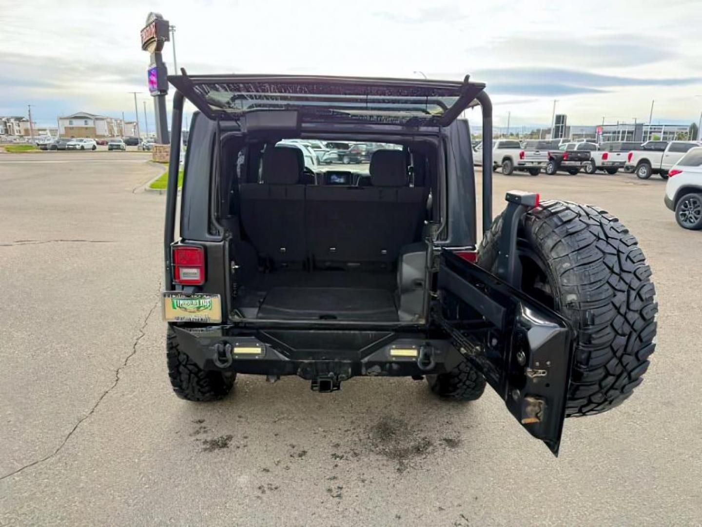 2011 Black Clearcoat /Black Jeep Wrangler Unlimited (1J4HA6H19BL) with an 38L V-6 regular unleaded engine, Automatic transmission, located at 1175 N Woodruff Ave, Idaho Falls, ID, 83401, 43.506901, -111.999657 - At Timberline Auto, finding a great deal on your next vehicle is always easy! Our experienced sales staff's goal is to help find you the right vehicle at the right price! Our knowledgeable finance department has options for almost any credit score. We offer extended service contract options to prote - Photo#4