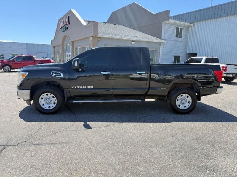 2016 Magnetic Black /Beige Nissan Titan XD SV (1N6BA1F32GN) with an V8, 5.0L engine, 6-speed automatic transmission, located at 1175 N Woodruff Ave, Idaho Falls, ID, 83401, 43.506901, -111.999657 - <b>Vehicle Details</b><br>Looking for a powerful pre-owned truck in Idaho Falls, ID? This 2016 Nissan Titan XD SV Diesel with 4WD delivers the strength, capability, and comfort truck shoppers want. Powered by a V8 5.0L Diesel engine, this Nissan Titan XD is built for towing, hauling, and confident d- Photo#1