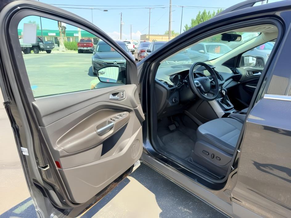 2014 BLACK /CLOTH Ford Escape (1FMCU9GX2EU) with an 16L I4 engine, Automatic transmission, located at 1175 N Woodruff Ave, Idaho Falls, ID, 83401, 43.506901, -111.999657 - Compact SUV practicality and everyday drivability come together in this 2014 Ford Escape 4WD equipped with a 1.6L EcoBoost turbocharged engine. Four wheel drive capability adds traction for changing road conditions while the compact SUV size keeps it easy to maneuver around town and in tighter parki- Photo#13