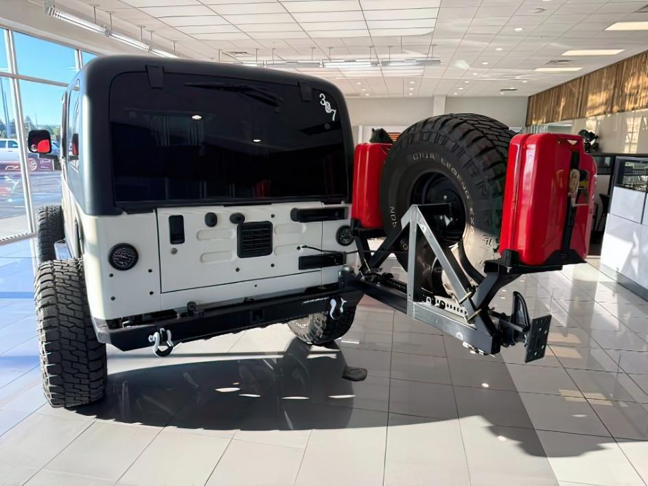 2005 WHITE /Dark Slate Gray Jeep Wrangler (1J4FA64S25P) with an Power Tech 4L I-6 regular unleaded engine, Manual transmission, located at 1175 N Woodruff Ave, Idaho Falls, ID, 83401, 43.506901, -111.999657 - This 2005 Jeep Wrangler is a purpose-built off-road rig designed for capability, durability, and adventure-ready performance. Built on the iconic Wrangler platform known for its trail-tested strength and removable-top freedom, it has been enhanced with a range of functional upgrades that elevate its - Photo#4