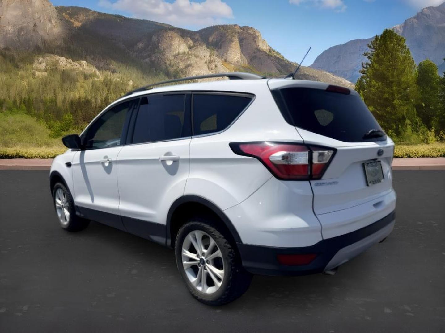 2018 WHITE /Medium Light Stone Ford Escape (1FMCU9HD1JU) with an EcoBoost 15L I-4 gasoline direct injection engine, Automatic transmission, located at 1175 N Woodruff Ave, Idaho Falls, ID, 83401, 43.506901, -111.999657 - At Timberline Auto, finding a great deal on your next vehicle is always easy! Our experienced sales staff goal is to help find you the right vehicle at the right price! Our knowledgeable finance department has options for almost any credit score. We offer extended service contract options to prot- Photo#2