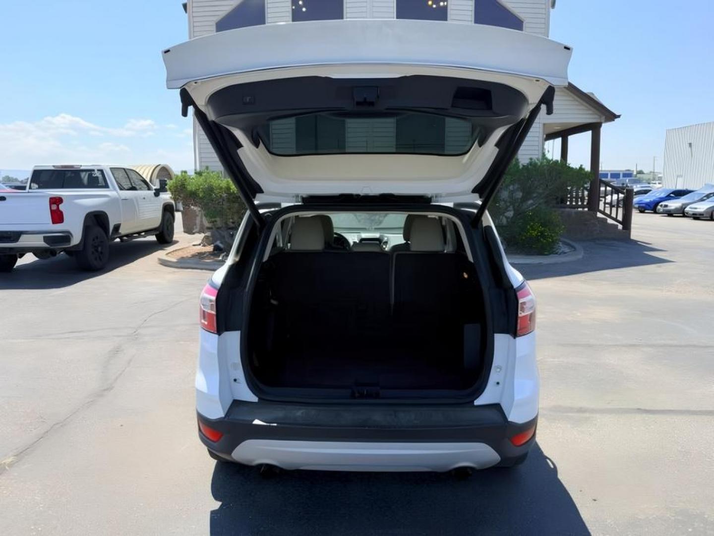 2018 WHITE /Medium Light Stone Ford Escape (1FMCU9HD1JU) with an EcoBoost 15L I-4 gasoline direct injection engine, Automatic transmission, located at 1175 N Woodruff Ave, Idaho Falls, ID, 83401, 43.506901, -111.999657 - At Timberline Auto, finding a great deal on your next vehicle is always easy! Our experienced sales staff goal is to help find you the right vehicle at the right price! Our knowledgeable finance department has options for almost any credit score. We offer extended service contract options to prot- Photo#5